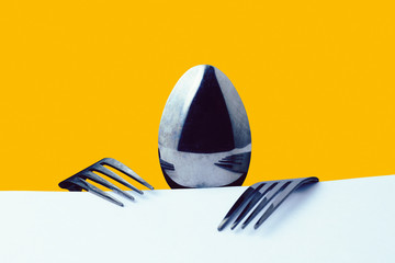 A spoon and two forks metaphorically depict a hungry man sitting at a table. Conceptual abstraction of emotions and souls of objects. Toned