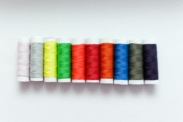 Collection of Colourful thread spools isolated on a white
