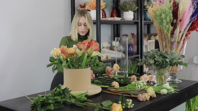 Florist woman make a beautiful flowers bouquet