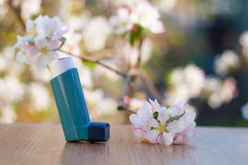 Inhaler for asthma with a blossoming apple tree
