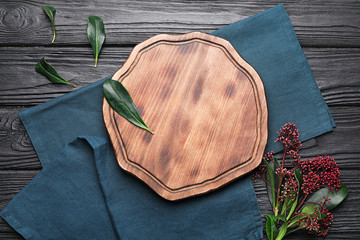 Clean napkins with cutting board on wooden background