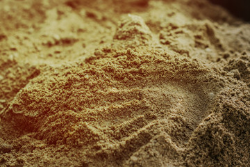 a child's handprint in the sand
