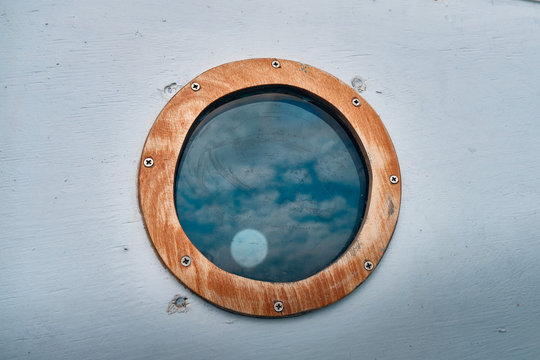 ship window or porthole on white wooden wall