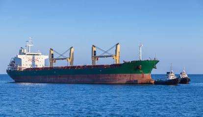 Bulk carrier and a tug boat are on the way