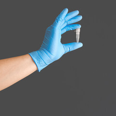 Plastic container for laboratory blood test in the hand of a doctor