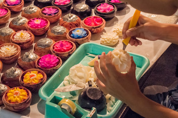 sculptor making flowers on soap at night market in Chiang Mai Thailand