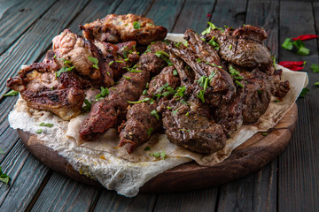 Assorted grilled meats: beef, pork, poultry, lamb. Juicy slices of meat delicacies. Food for a big company, a picnic.