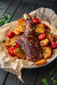 Grilled lamb leg. Juicy meat with vegetables.
