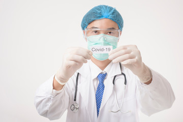 Doctor is holding Covid-19 card on white background