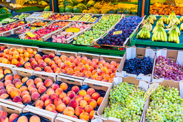 Colorful and juicy fruits on stalls in a local fruit market