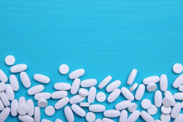 Heap of pills on blue