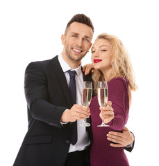 Happy couple with glasses of champagne on white background