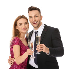 Happy couple with glasses of champagne on white background