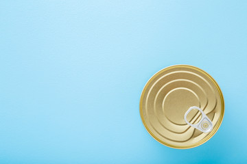 New metallic preserved can for different food storage. Light blue table background. Pastel color. Healthy eating. Closeup. Empty place for text or logo. Top down view. © fotoduets