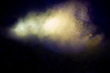 Fog on stage during a rock concert on a dark background.