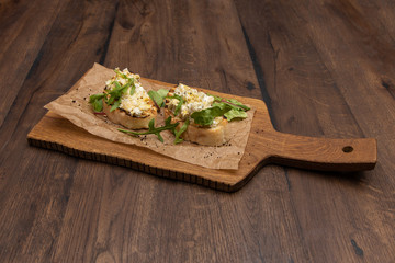 Bruschetta with artichokes on a wooden Board.