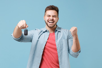 Happy young bearded guy 20s in casual shirt posing isolated on pastel blue wall background studio...