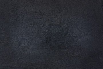 surface of the stucco wall in a dark blue tone.