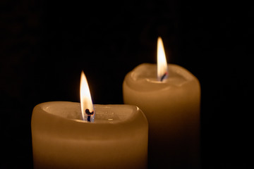 two candlelights in the darkness