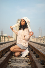 Fototapeta na wymiar A young beautiful girl poses on an old bridge.