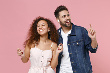Cheerful young couple two friends european guy african american girl in casual clothes posing...