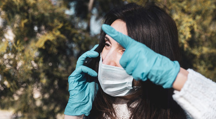 woman in a medical mask with a mobile phone