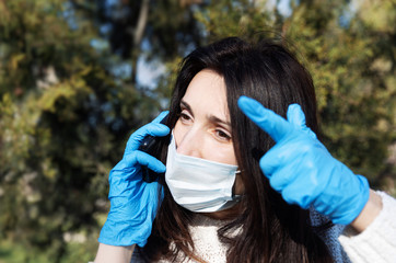 woman in a medical mask with a mobile phone