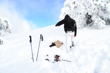 a man with ski equipment on the top of the mountain 