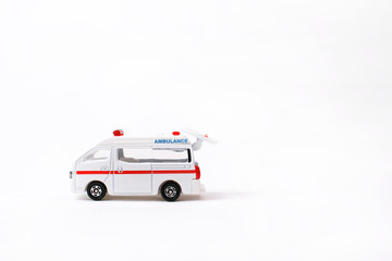 Emergency Ambulance toy car and open door on white background                                                                   