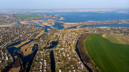 Bird's-eye view to village, streets, roads, islands and river delta.