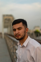Fototapeta premium Man poses on an old bridge.