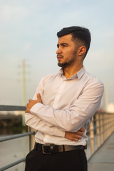 Fototapeta premium Man poses on an old bridge.