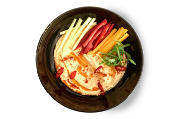 black plate with vegetables on a white background 