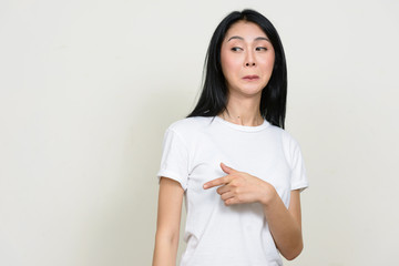 Portrait of young Asian woman gossiping while pointing finger