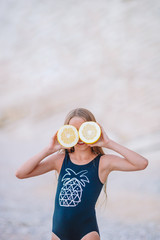 Adorable little girl have fun at tropical beach during vacation