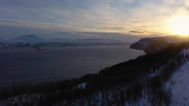 Ofotfjord Fjord and Mountains in Winter at Sunset. Norway. Aerial View. Drone Flies Forward, Tilt Up. Reveal Shot