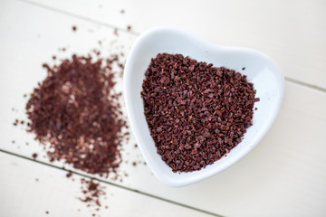 sumac powder on white wooden background