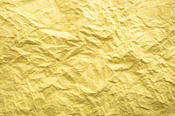 Yellow crumpled paper background. Twisted yellow paper. Seamless pattern.
