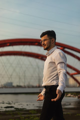 Fototapeta premium Man poses on an old bridge.