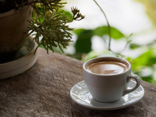 Hot coffee americano on the old wooden table
