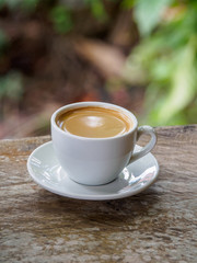 Hot coffee americano on the old wooden table