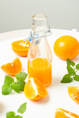 orange juice and fruits on white