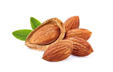 Almonds with leaves in closeup isolated on white background.