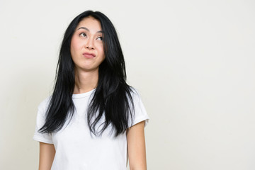 Fototapeta premium Portrait of stressed young Asian woman looking bored and tired