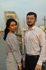 Two people posing on an old bridge in Vietnam.