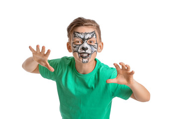 Funny little boy with face painting on white background