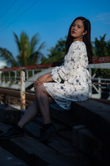 Fototapeta premium Vietnamese girl standing on an old bridge