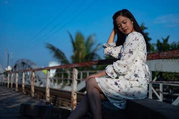 Fototapeta na wymiar Vietnamese girl standing on an old bridge