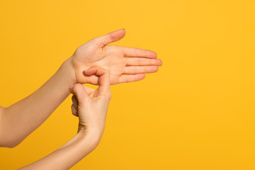 Cropped view of girl using deaf and dumb language isolated on yellow