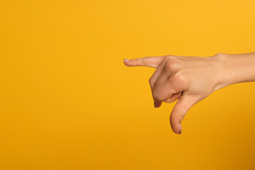Cropped view of woman using deaf and dumb language isolated on yellow
